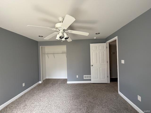 unfurnished bedroom with a closet, visible vents, baseboards, and carpet floors