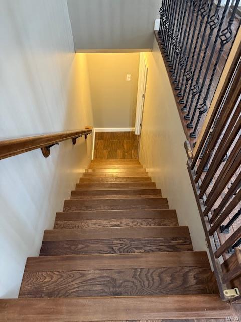 stairway with wood finished floors