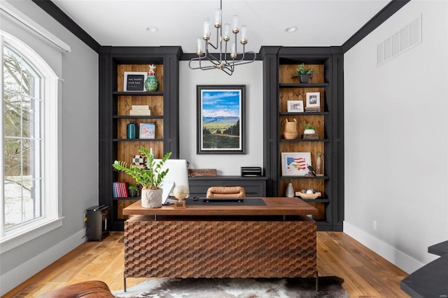 home office with visible vents, baseboards, an inviting chandelier, and light wood-style flooring