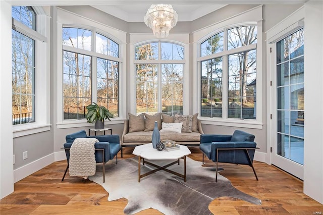 sunroom featuring a chandelier