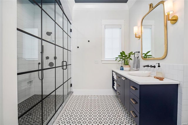 bathroom featuring vanity, crown molding, baseboards, and a shower stall