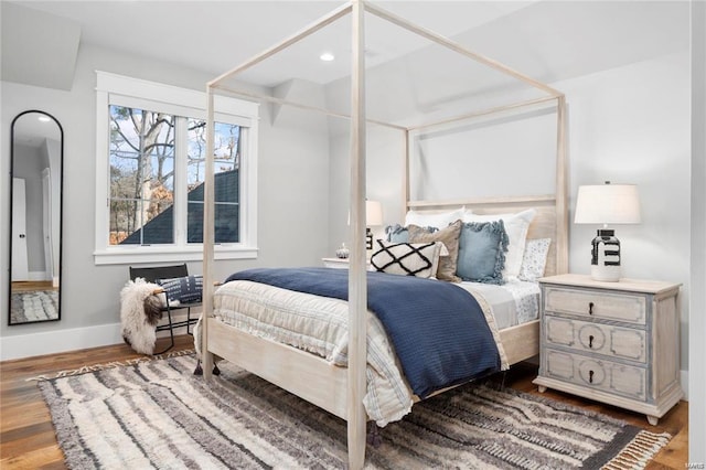 bedroom with recessed lighting, baseboards, and wood finished floors