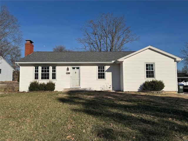 ranch-style home with a front lawn, roof with shingles, and a chimney