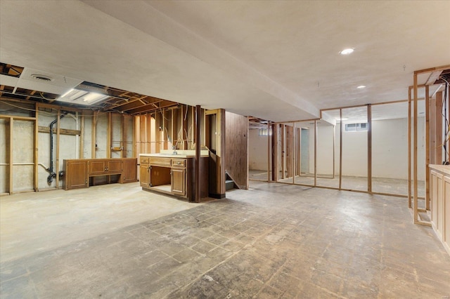 unfinished basement with stairs, recessed lighting, visible vents, and a sink