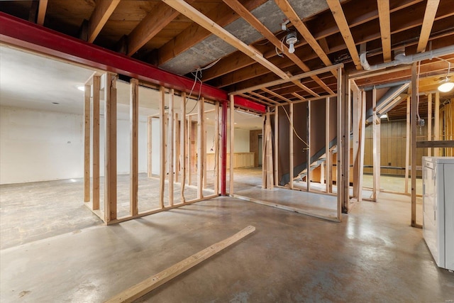 unfinished basement featuring washer / dryer