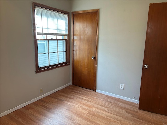 empty room with light wood-style flooring and baseboards