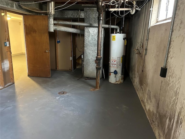 basement featuring gas water heater and heating unit