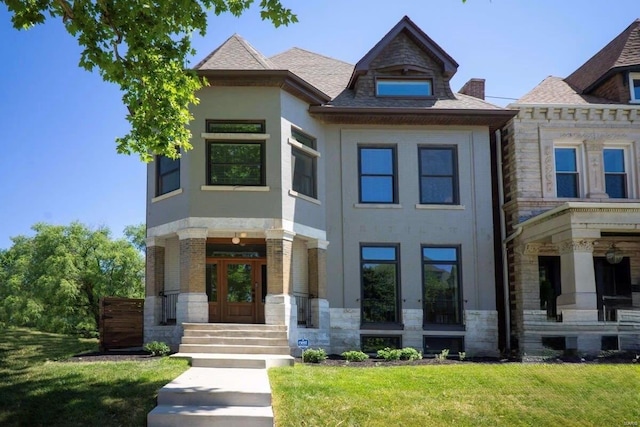 view of front of property with a front yard, french doors, and stone siding