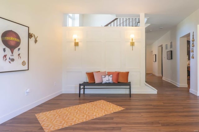 sitting room featuring baseboards and wood finished floors