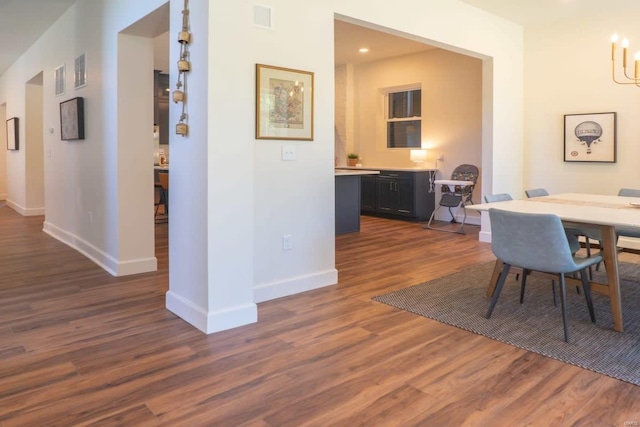 dining room featuring visible vents, dark wood-type flooring, and baseboards