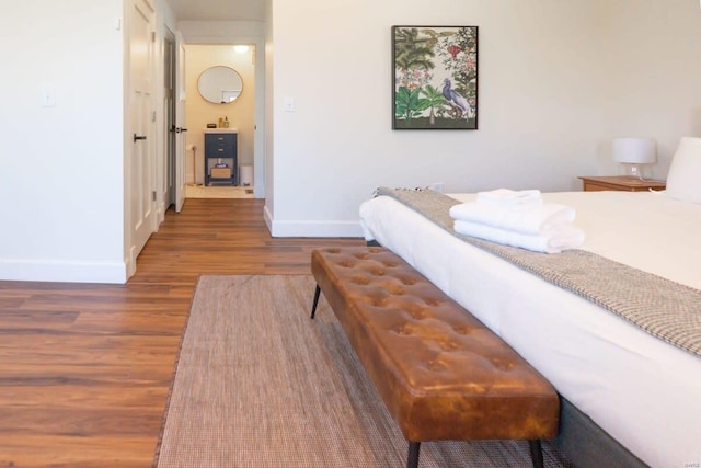 bedroom featuring baseboards and wood finished floors