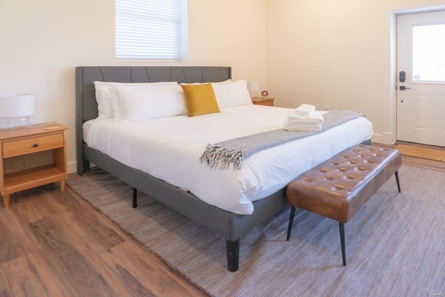 bedroom with wood finished floors and baseboards