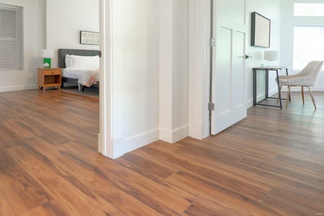 hallway with wood finished floors and baseboards