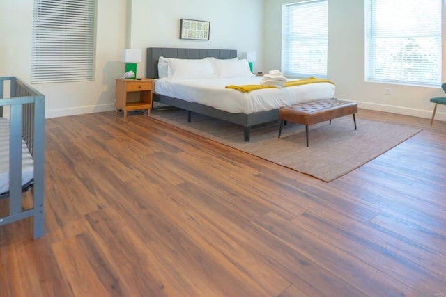 bedroom featuring baseboards and wood finished floors