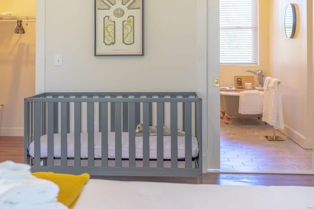 bedroom with baseboards and wood finished floors