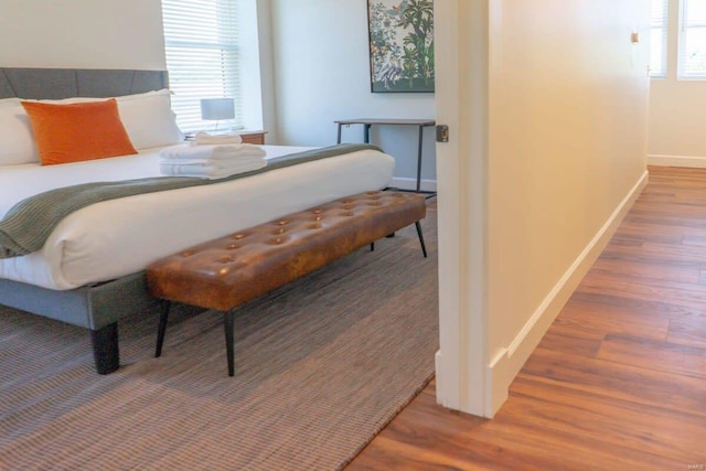 bedroom featuring baseboards and wood finished floors