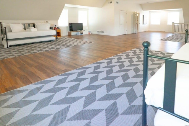 unfurnished bedroom featuring visible vents, baseboards, and wood finished floors