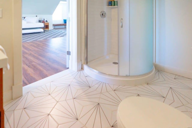 bathroom featuring tile patterned floors, a stall shower, and baseboards