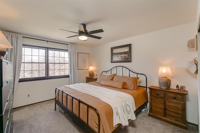 carpeted bedroom featuring a ceiling fan and baseboards