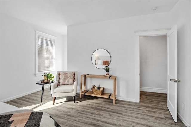 living area featuring baseboards and wood finished floors