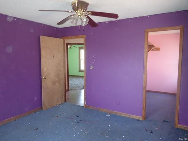 spare room featuring baseboards and ceiling fan