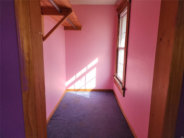 carpeted spare room with baseboards