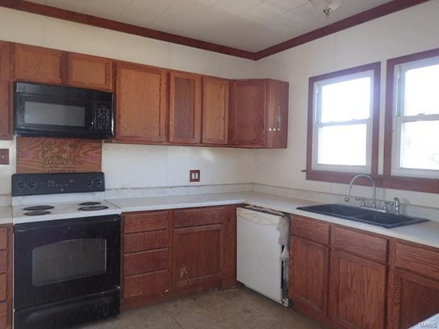 kitchen featuring a sink, black microwave, white dishwasher, brown cabinetry, and range with electric cooktop