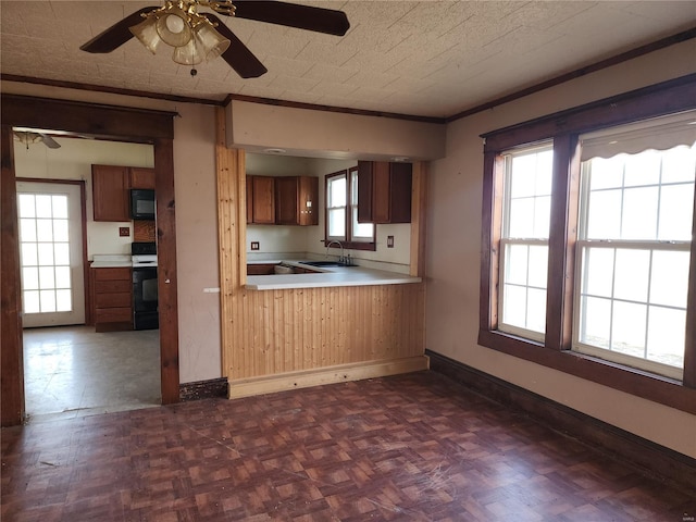 kitchen with ornamental molding, a sink, a ceiling fan, black microwave, and range with electric cooktop