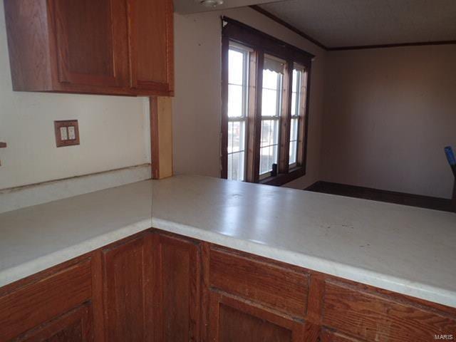 kitchen featuring brown cabinets and light countertops