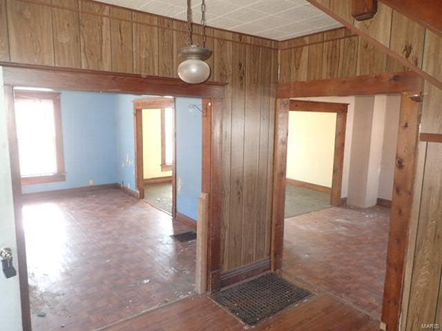 spare room with wooden walls
