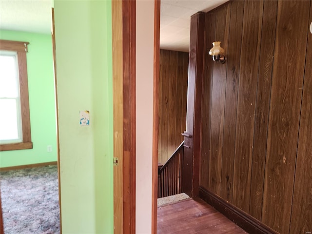 hall with baseboards and a wealth of natural light