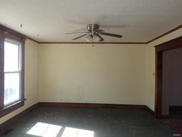 empty room with a ceiling fan, baseboards, and a healthy amount of sunlight