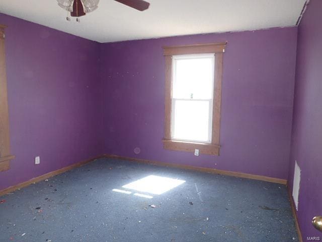 unfurnished room featuring baseboards and a ceiling fan