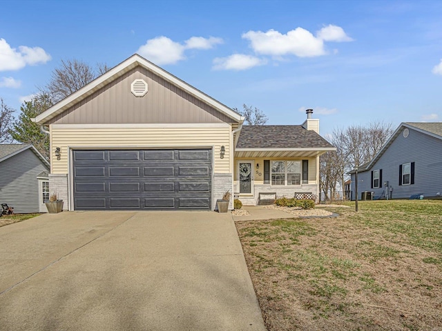 ranch-style home featuring driveway, stone siding, a front yard, an attached garage, and a chimney