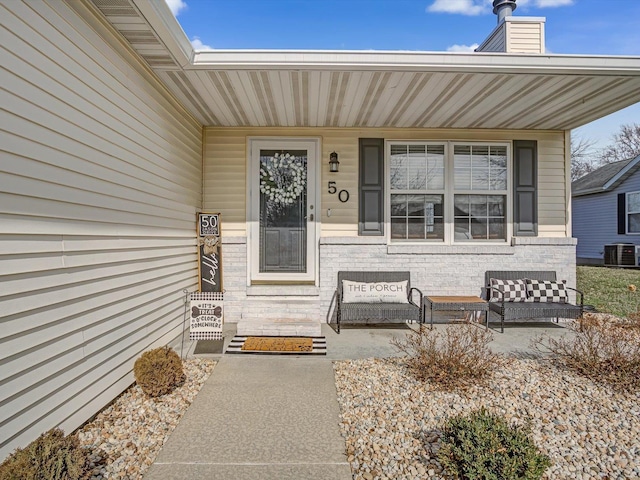 property entrance featuring a porch and cooling unit