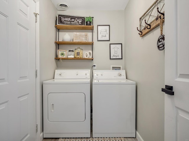 washroom with laundry area, visible vents, and independent washer and dryer