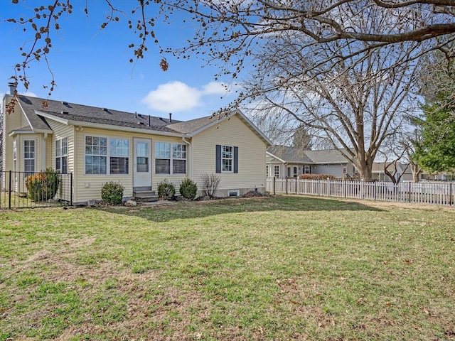 rear view of property with a yard, a fenced backyard, and entry steps