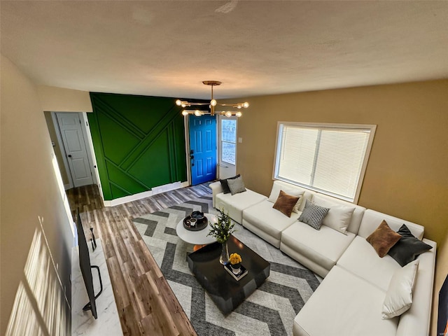 living area featuring a notable chandelier and wood finished floors