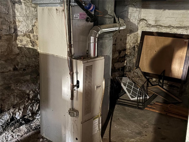 utility room featuring heating unit