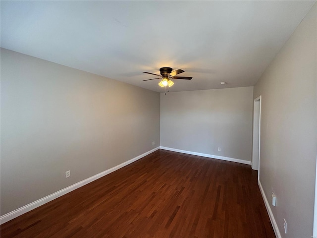 unfurnished room with dark wood finished floors, baseboards, and ceiling fan