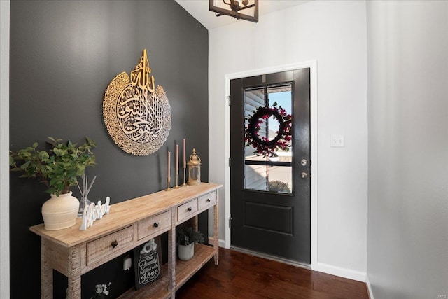 entrance foyer featuring baseboards and wood finished floors