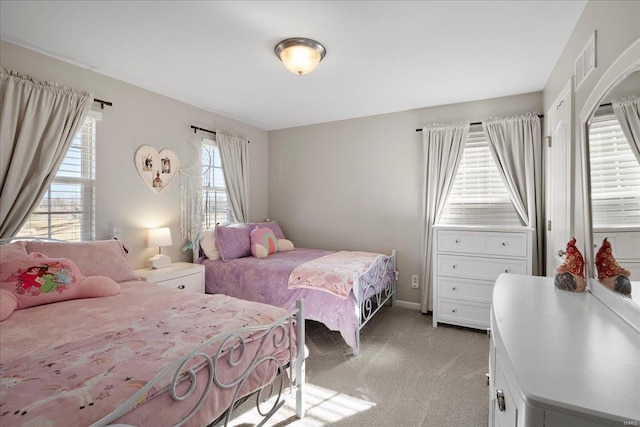 bedroom featuring light carpet and visible vents