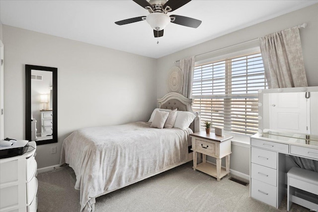 bedroom with visible vents, light colored carpet, a ceiling fan, and baseboards