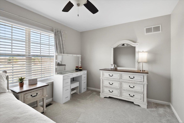 bedroom featuring visible vents, light carpet, and baseboards