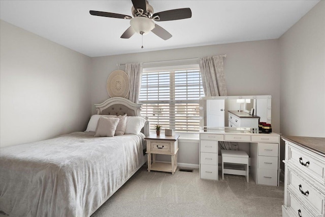 bedroom with a ceiling fan, visible vents, and light carpet