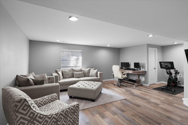 living room featuring recessed lighting, baseboards, and wood finished floors