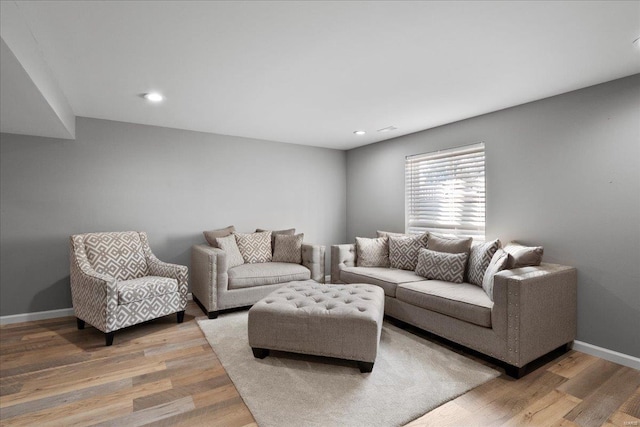 living area with recessed lighting, baseboards, and light wood-style floors