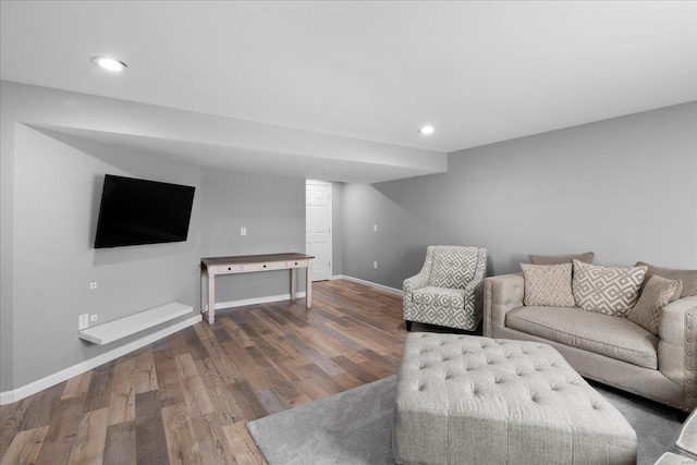 living room featuring recessed lighting, baseboards, and wood finished floors