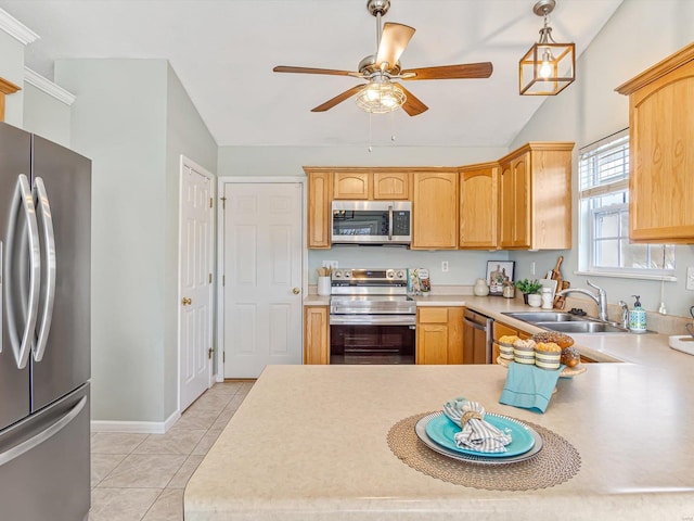 kitchen featuring a sink, appliances with stainless steel finishes, light countertops, light tile patterned floors, and lofted ceiling