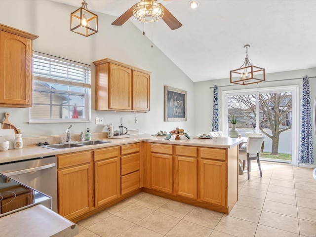 kitchen featuring a sink, a peninsula, and light countertops